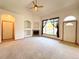 Living room with a fireplace, large window, carpet flooring, and a vaulted ceiling at 3231 E 102Nd Pl, Thornton, CO 80229