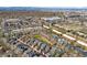 Neighborhood aerial view showcases a blend of residential buildings with mature trees and distant mountains at 2831 Spruce St, Denver, CO 80238