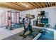 Finished basement with home gym featuring weight rack, bike, and other workout equipment at 2831 Spruce St, Denver, CO 80238