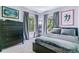 Comfortable bedroom with gray walls, large windows, and a black dresser for ample storage at 2831 Spruce St, Denver, CO 80238