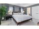 Spacious bedroom with hardwood floors, large windows, and stylish bedside tables with lamps at 2831 Spruce St, Denver, CO 80238