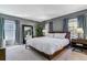 Serene bedroom with natural light, a large mirror, and a plush bed for ultimate relaxation at 2831 Spruce St, Denver, CO 80238