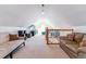 Expansive bonus room with ample seating, natural light, and a staircase to another level at 2831 Spruce St, Denver, CO 80238