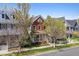 Charming brick home with a inviting front porch and manicured lawn, perfect for relaxing at 2831 Spruce St, Denver, CO 80238