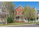 Charming brick home with a inviting front porch and manicured lawn, perfect for relaxing at 2831 Spruce St, Denver, CO 80238