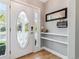 Bright foyer with gleaming wood floors and a stylish oval-glass front door at 2831 Spruce St, Denver, CO 80238