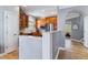 An open kitchen with wooden cabinetry and stainless steel appliances leads into the home at 2831 Spruce St, Denver, CO 80238