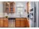 Kitchen featuring warm wood cabinets, granite countertops and stainless steel appliances at 2831 Spruce St, Denver, CO 80238
