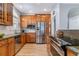 Well-lit kitchen features stainless steel appliances and warm wood cabinetry at 2831 Spruce St, Denver, CO 80238