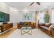 Bright living room featuring hardwood floors, stylish furniture, and lots of natural light at 2831 Spruce St, Denver, CO 80238