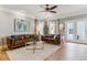 Comfortable living room features leather sofas, hardwood floors, and bright natural light at 2831 Spruce St, Denver, CO 80238