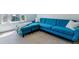 Bright living room features a stylish blue sectional sofa and natural light from the window at 2831 Spruce St, Denver, CO 80238