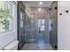 Modern shower with glass enclosure, gray tile, and a rainfall showerhead for a luxurious experience at 2831 Spruce St, Denver, CO 80238
