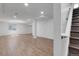 Bright basement area features a hardwood floor, staircase, recessed lighting, and white support beams at 3653 E 133Rd Ct, Thornton, CO 80241