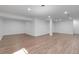Spacious basement area boasts hardwood flooring, recessed lights, and bright white walls and pillars at 3653 E 133Rd Ct, Thornton, CO 80241