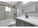 Updated bathroom with stylish vanity, framed mirror, and sleek black hardware in the shower with glass door at 3653 E 133Rd Ct, Thornton, CO 80241