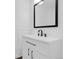 Bathroom featuring white vanity, black hardware, and modern mirror at 3653 E 133Rd Ct, Thornton, CO 80241