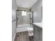 Beautifully renovated bathroom with gray vanity, modern fixtures, and glass enclosed shower at 3653 E 133Rd Ct, Thornton, CO 80241