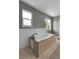 This bathroom showcases a relaxing soaking tub with a tiled surround and modern fixtures at 3653 E 133Rd Ct, Thornton, CO 80241