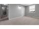 Neutral bedroom with sliding closet door, carpet floors, and natural light streaming through a window at 3653 E 133Rd Ct, Thornton, CO 80241
