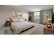 Stylishly staged bedroom with a soft color palette, window, and complementary decor offers a cozy retreat at 3653 E 133Rd Ct, Thornton, CO 80241