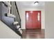 Entryway features wood floors, stairs to the left, and a red front door at 3653 E 133Rd Ct, Thornton, CO 80241