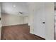 View of empty living room featuring wood floors, ceiling fan, and white door at 3653 E 133Rd Ct, Thornton, CO 80241