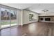Living room with hardwood floors, brick fireplace, large windows and sliding glass door to the backyard at 3653 E 133Rd Ct, Thornton, CO 80241