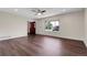 View of empty living room featuring wood floors, ceiling fan, and a large window at 3653 E 133Rd Ct, Thornton, CO 80241