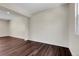 View of empty living room featuring wood floors, and a large window at 3653 E 133Rd Ct, Thornton, CO 80241