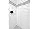Close-up of shower featuring white subway tile with gray border and black hardware at 3653 E 133Rd Ct, Thornton, CO 80241