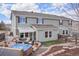 A home's backyard with a deck, fire pit, seating, hot tub, and lush landscaping at 5671 Raleigh Cir, Castle Rock, CO 80104