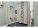 Modern shower stall with clear glass, marble and decorative stone details and built in seating at 5671 Raleigh Cir, Castle Rock, CO 80104