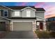 Charming home featuring a two-car garage, stone accents and craftsman details at sunset at 5671 Raleigh Cir, Castle Rock, CO 80104