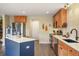Bright kitchen featuring stainless steel appliances, wood cabinets and a center island with blue paneling at 5671 Raleigh Cir, Castle Rock, CO 80104
