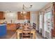 This kitchen has wood cabinetry, stainless appliances, and a center island, adjacent to the dining area at 5671 Raleigh Cir, Castle Rock, CO 80104