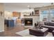 Open-concept living room with fireplace, leading to a spacious kitchen at 5671 Raleigh Cir, Castle Rock, CO 80104