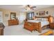 Large main bedroom with wood furniture, including a king bed, dresser, and nightstands at 5671 Raleigh Cir, Castle Rock, CO 80104