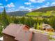 Breathtaking aerial view of a mountain home surrounded by lush trees and a backdrop of snow-capped mountains at 322 Davis Ct, Breckenridge, CO 80424