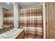 Full bathroom with a single sink, framed mirror, and a shower and tub combination with a decorative shower curtain at 322 Davis Ct, Breckenridge, CO 80424