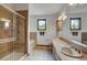Bathroom featuring a shower with glass door, soaking tub, and dual sinks at 322 Davis Ct, Breckenridge, CO 80424