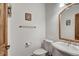 Powder room features a pedestal sink, toilet, and wood-framed mirror at 322 Davis Ct, Breckenridge, CO 80424