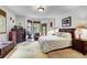 A bedroom with neutral-toned carpet, wood furniture, and a comfortable chair at 322 Davis Ct, Breckenridge, CO 80424