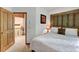 Comfortable bedroom with neutral tones, patterned bedding, and decorative wall art, leading to the upper floor via an open wood door at 322 Davis Ct, Breckenridge, CO 80424