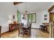 Dining area featuring hardwood floors, a hanging antler chandelier, and large windows at 322 Davis Ct, Breckenridge, CO 80424