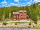 Stunning aerial view of a two-story home surrounded by lush greenery, showcasing the beauty of the natural landscape at 322 Davis Ct, Breckenridge, CO 80424