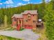 Stunning aerial view of a two-story home surrounded by lush greenery, showcasing the beauty of the natural landscape at 322 Davis Ct, Breckenridge, CO 80424