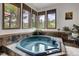Relaxing hot tub room with mountain views from multiple windows and stone tile surround at 322 Davis Ct, Breckenridge, CO 80424