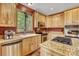 Well-lit kitchen featuring wood cabinets, granite countertops, stainless steel appliances, and a scenic view at 322 Davis Ct, Breckenridge, CO 80424