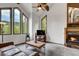 Comfortable living room showcasing a fireplace, large windows with scenic views, and vaulted ceilings with wood beams at 322 Davis Ct, Breckenridge, CO 80424